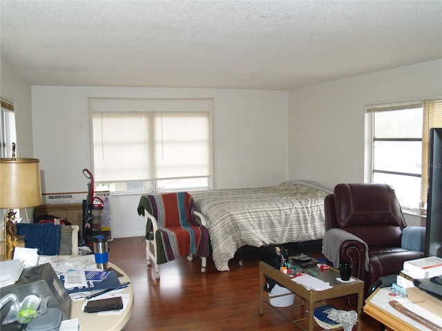 bedroom featuring a textured ceiling and wood-type flooring