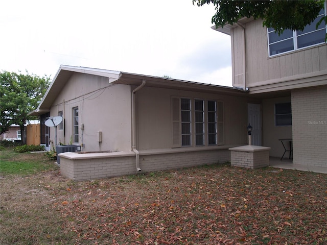 view of side of property featuring central AC and a patio area