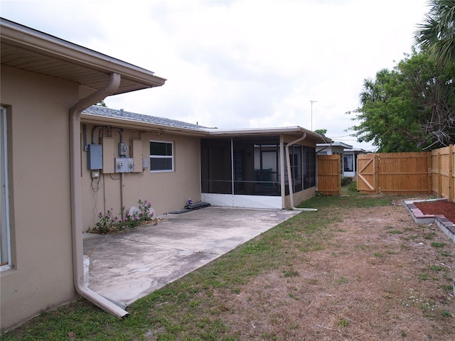 view of yard featuring a patio and a sunroom