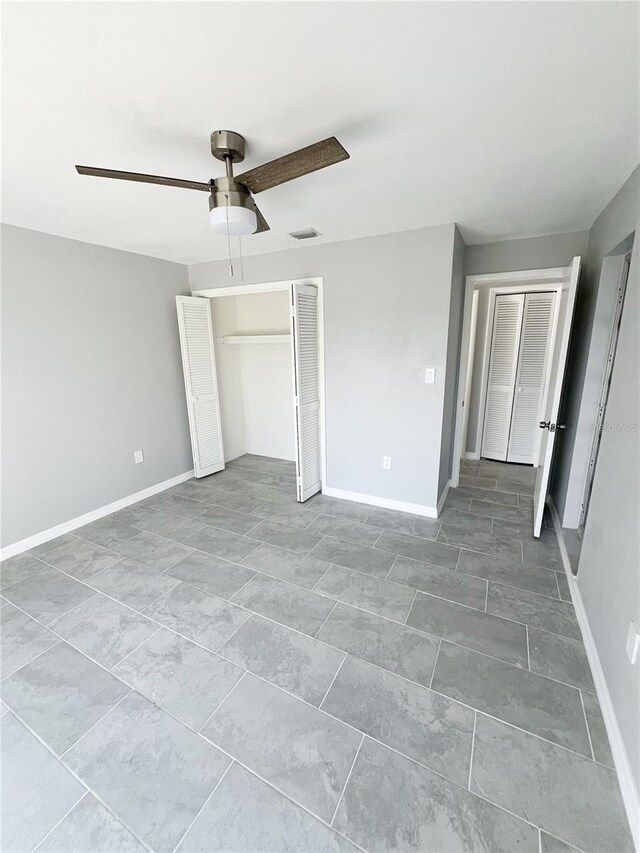 unfurnished bedroom with ceiling fan and tile floors