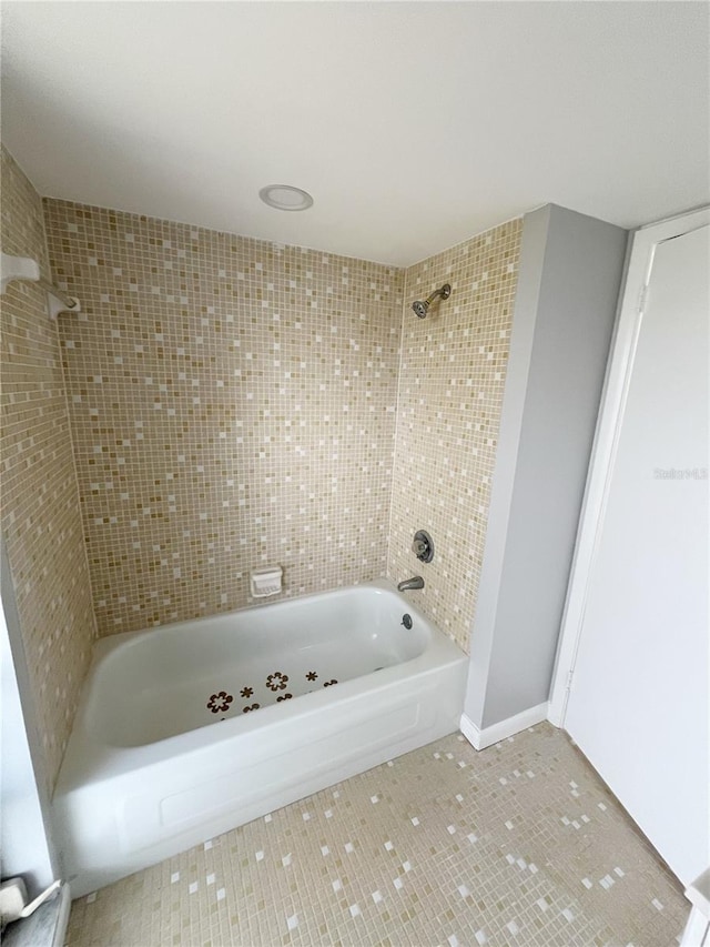 bathroom featuring tile flooring and tiled shower / bath combo