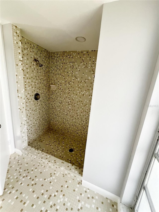 bathroom with a tile shower