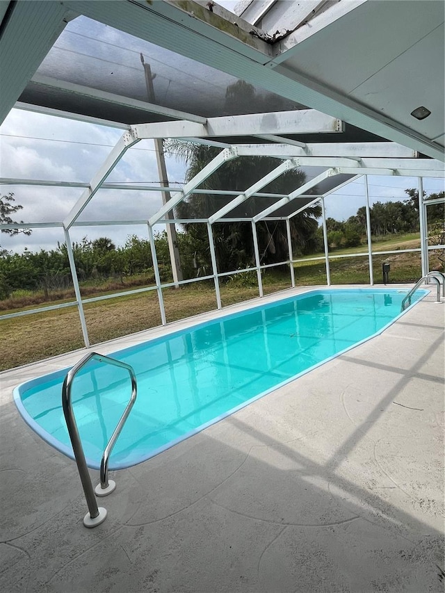 view of swimming pool featuring a patio and a lawn