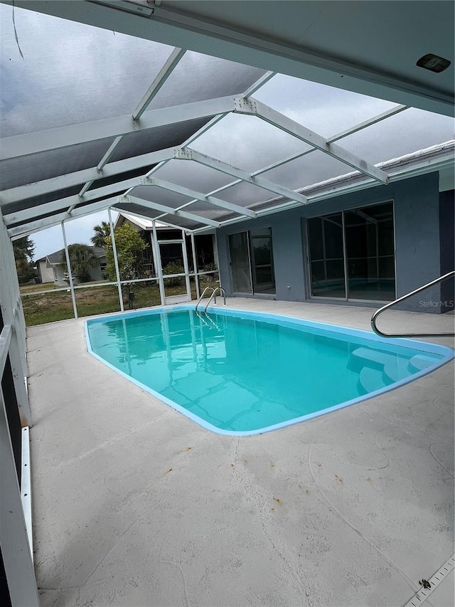 view of pool featuring a lanai and a patio area