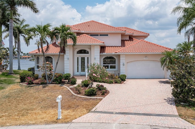 mediterranean / spanish house with a garage