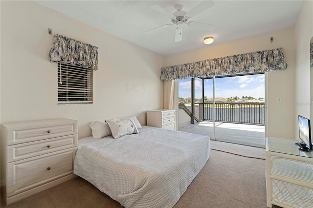 carpeted bedroom with ceiling fan and access to outside