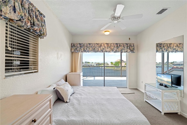 bedroom with multiple windows, carpet flooring, ceiling fan, and access to outside