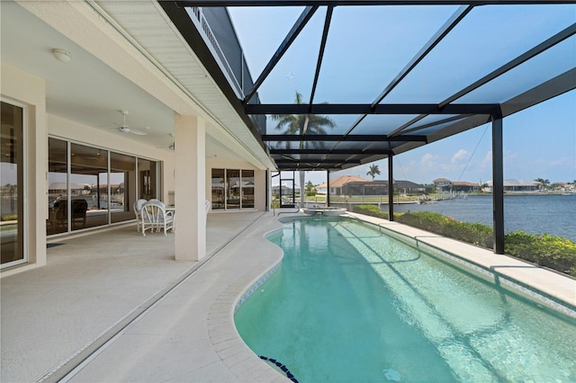 view of swimming pool with a lanai, a water view, ceiling fan, and a patio