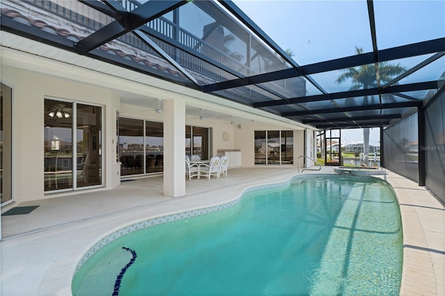 view of swimming pool featuring ceiling fan, a patio, an in ground hot tub, and a lanai