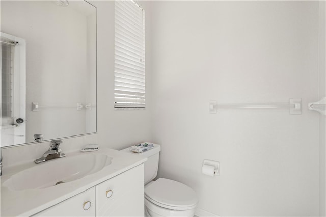 bathroom with toilet and vanity