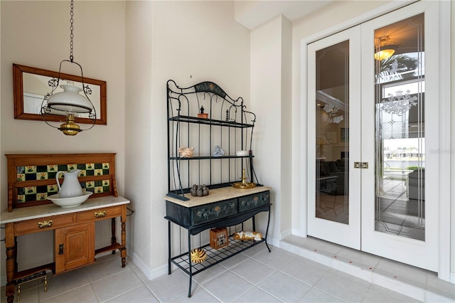 interior space with light tile patterned flooring and french doors