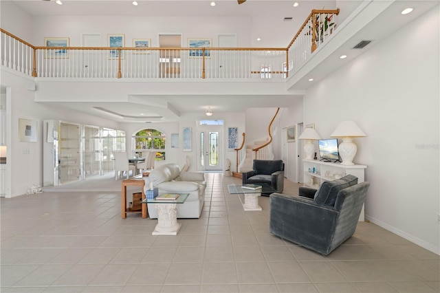 tiled living room featuring a towering ceiling