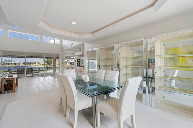 tiled dining space featuring a tray ceiling