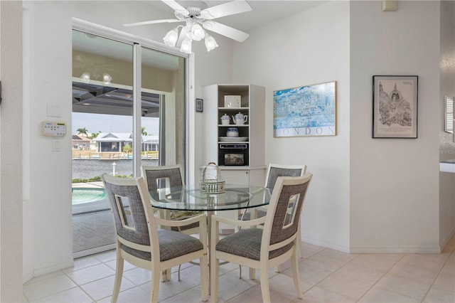 tiled dining space with ceiling fan