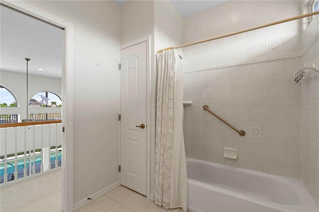 bathroom with shower / bath combo and tile patterned flooring