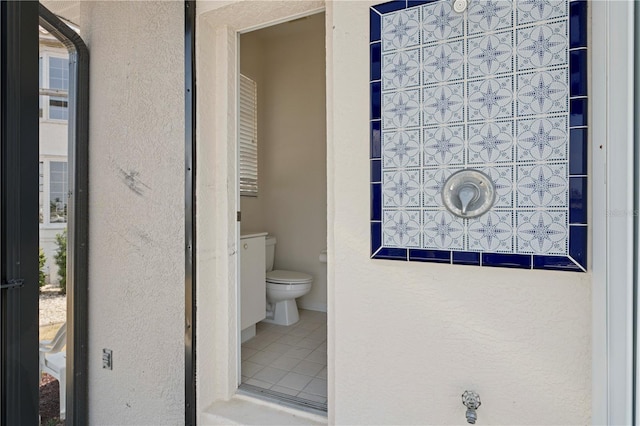 bathroom featuring toilet and tile patterned floors