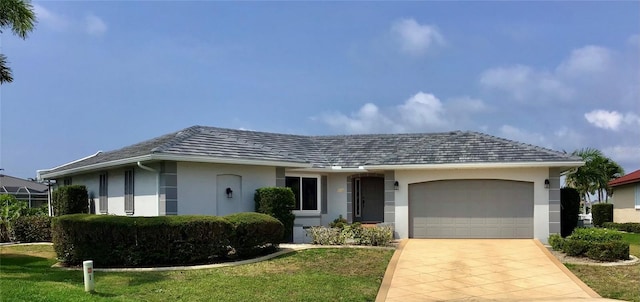 single story home featuring a garage and a front yard