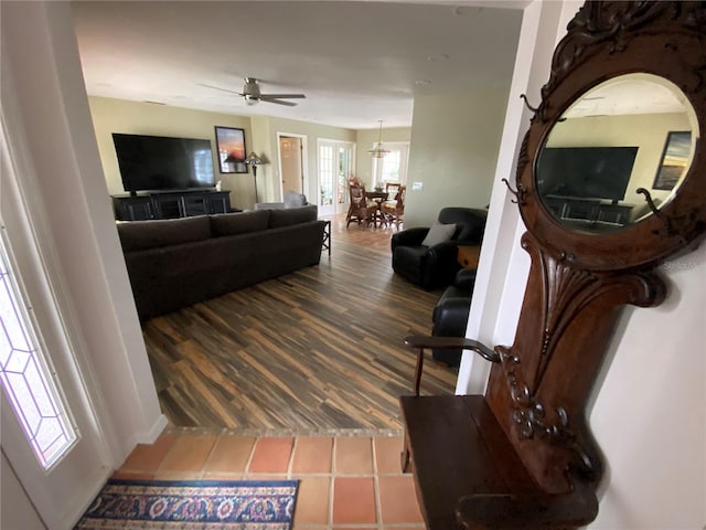 tiled living room with ceiling fan