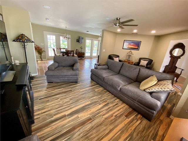 living room with wood-type flooring, ceiling fan, and french doors