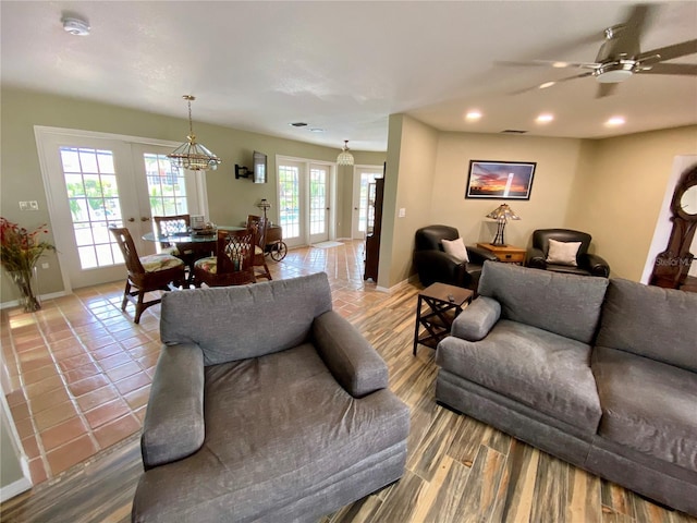 living room with ceiling fan, french doors, and wood-type flooring