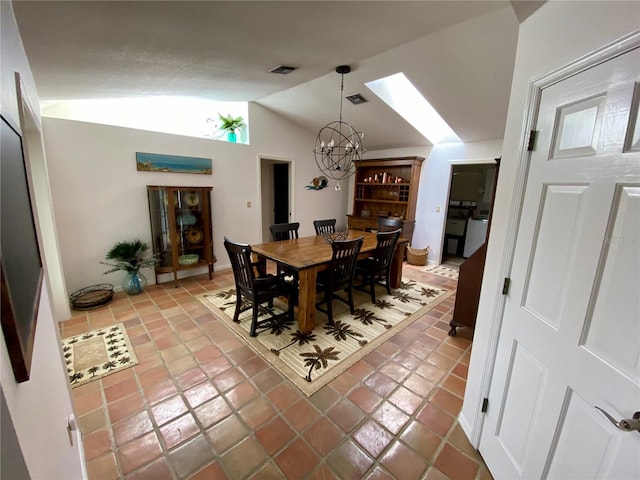 dining room featuring an inviting chandelier, tile flooring, and vaulted ceiling with skylight