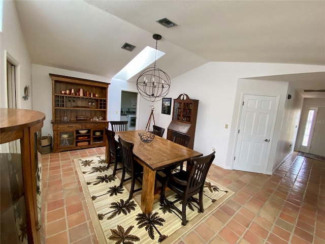 tiled dining area featuring a notable chandelier and lofted ceiling