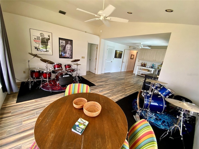 dining area with lofted ceiling, wood-type flooring, and ceiling fan