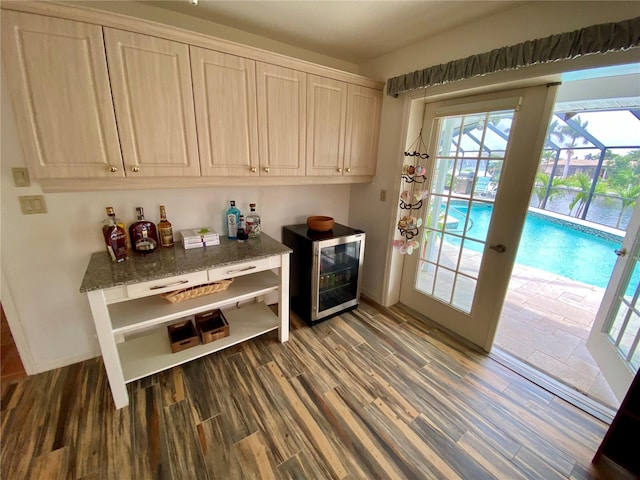 interior space with beverage cooler, french doors, and hardwood / wood-style floors