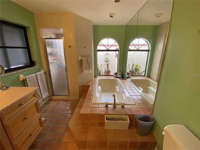 bathroom with shower with separate bathtub, vanity, and tile floors