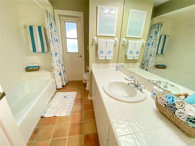 bathroom featuring a tub, tile flooring, vanity, and toilet