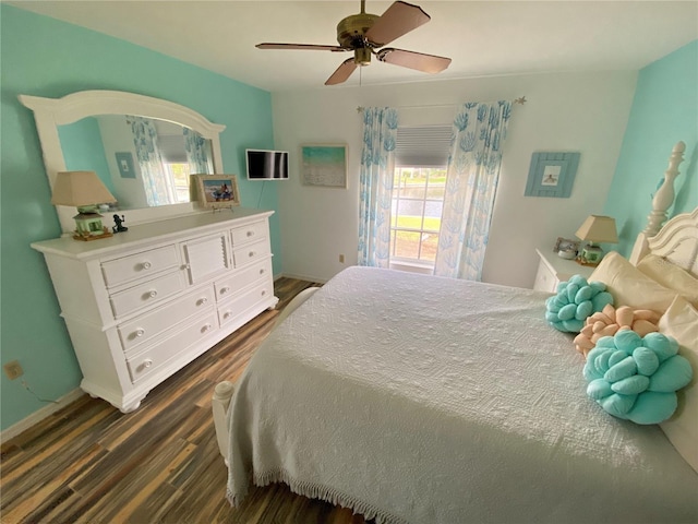 bedroom with ceiling fan and dark hardwood / wood-style flooring