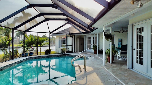 view of swimming pool with a patio area, ceiling fan, and french doors