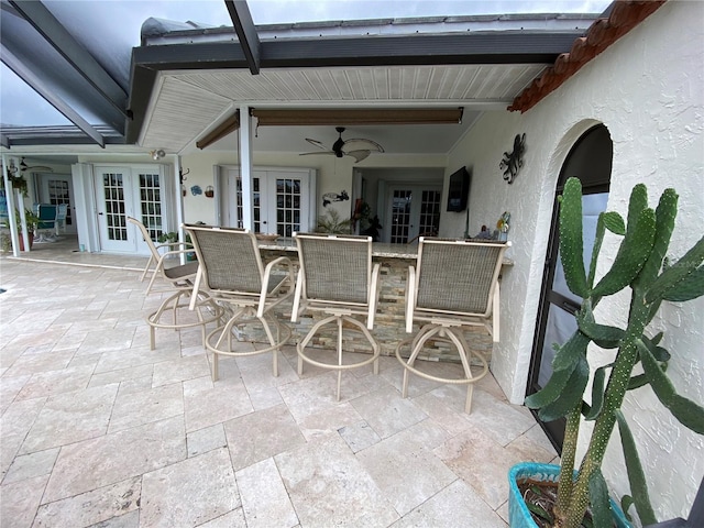 view of patio / terrace with french doors, ceiling fan, and an outdoor bar