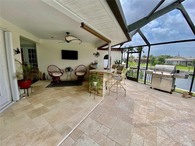 sunroom featuring ceiling fan