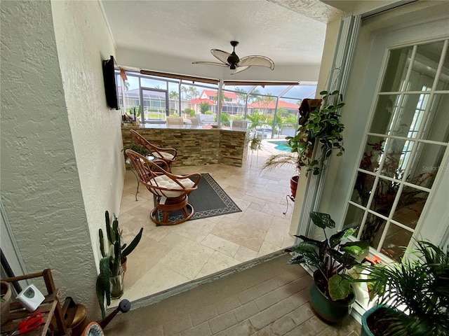 sunroom featuring ceiling fan