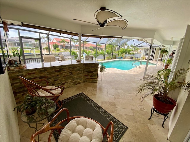 view of pool featuring a patio, a lanai, and ceiling fan