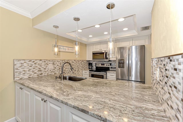 kitchen with light stone countertops, appliances with stainless steel finishes, white cabinetry, decorative backsplash, and sink