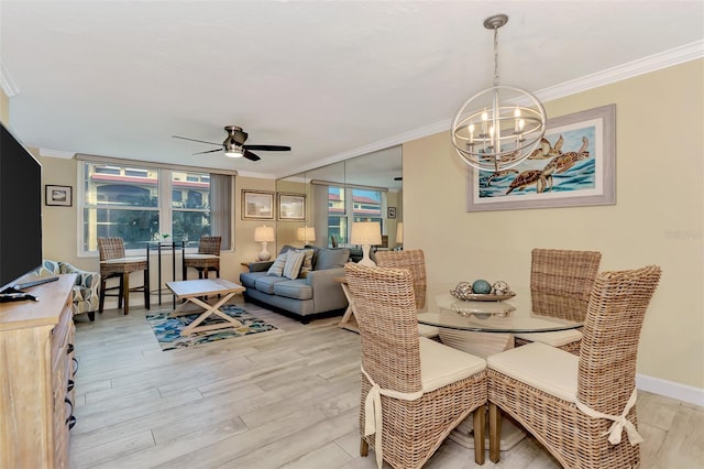 dining area featuring light wood-type flooring, ceiling fan with notable chandelier, and ornamental molding