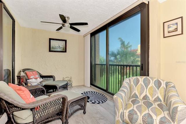 sunroom / solarium featuring ceiling fan