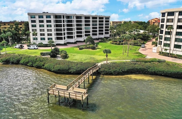 view of property's community featuring a water view and a lawn