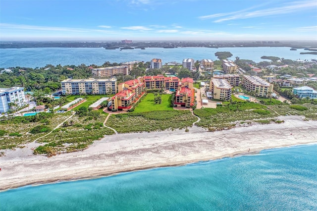 birds eye view of property featuring a water view and a beach view