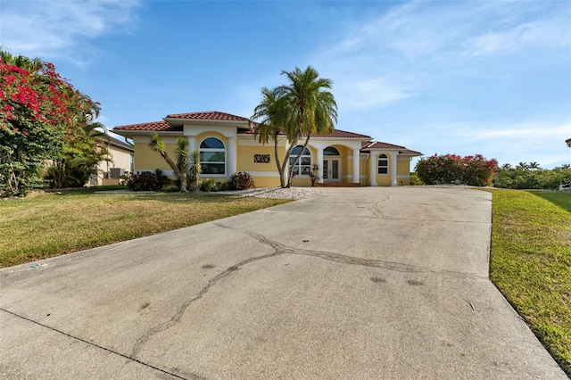 mediterranean / spanish home featuring a front lawn