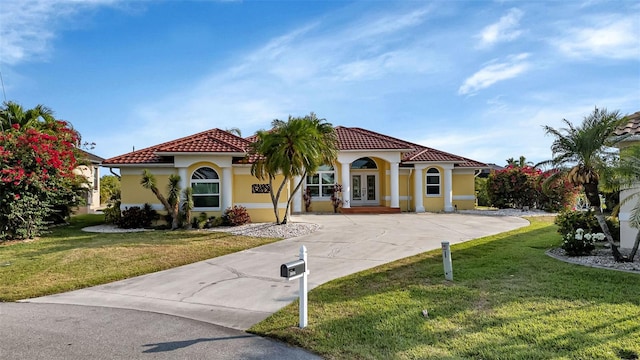 mediterranean / spanish-style home featuring a front yard