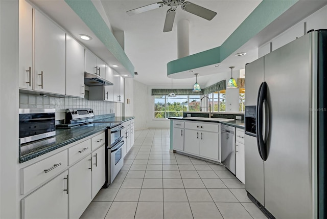 kitchen featuring decorative light fixtures, stainless steel appliances, ceiling fan, white cabinets, and light tile floors