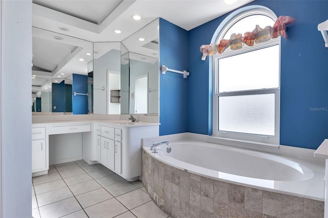 bathroom with tile floors, a wealth of natural light, a relaxing tiled bath, and oversized vanity