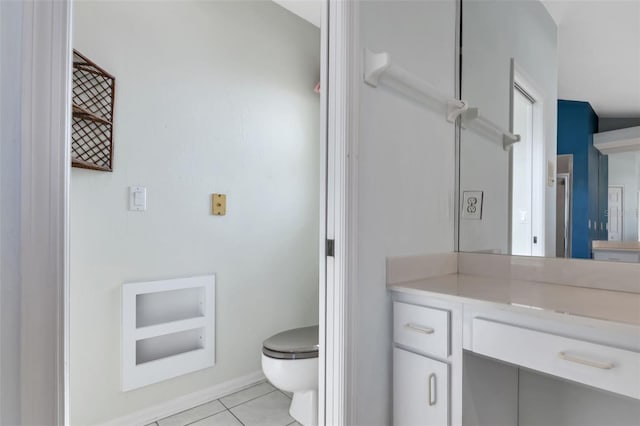 bathroom featuring tile floors, oversized vanity, and toilet