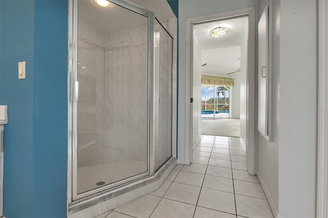 bathroom featuring tile flooring and a shower with door