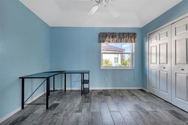 bedroom with ceiling fan, a closet, and hardwood / wood-style flooring