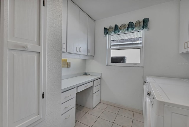 interior space featuring separate washer and dryer, light tile floors, and cabinets