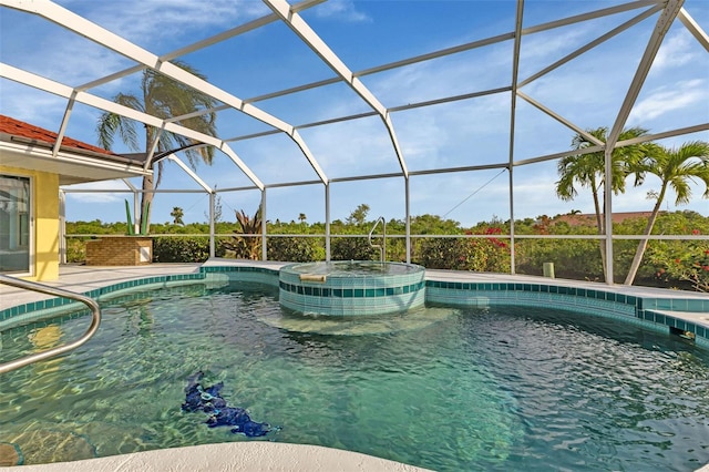 view of pool featuring a lanai and an in ground hot tub